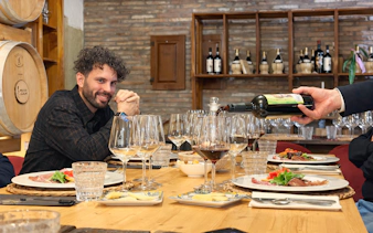 Wine tasting setup with glasses and plates during Chianti day trip in Italy.