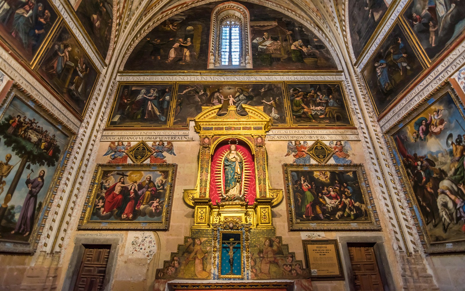 Chapel interior with religious paintings and altar inside the Cathedral of Segovia.