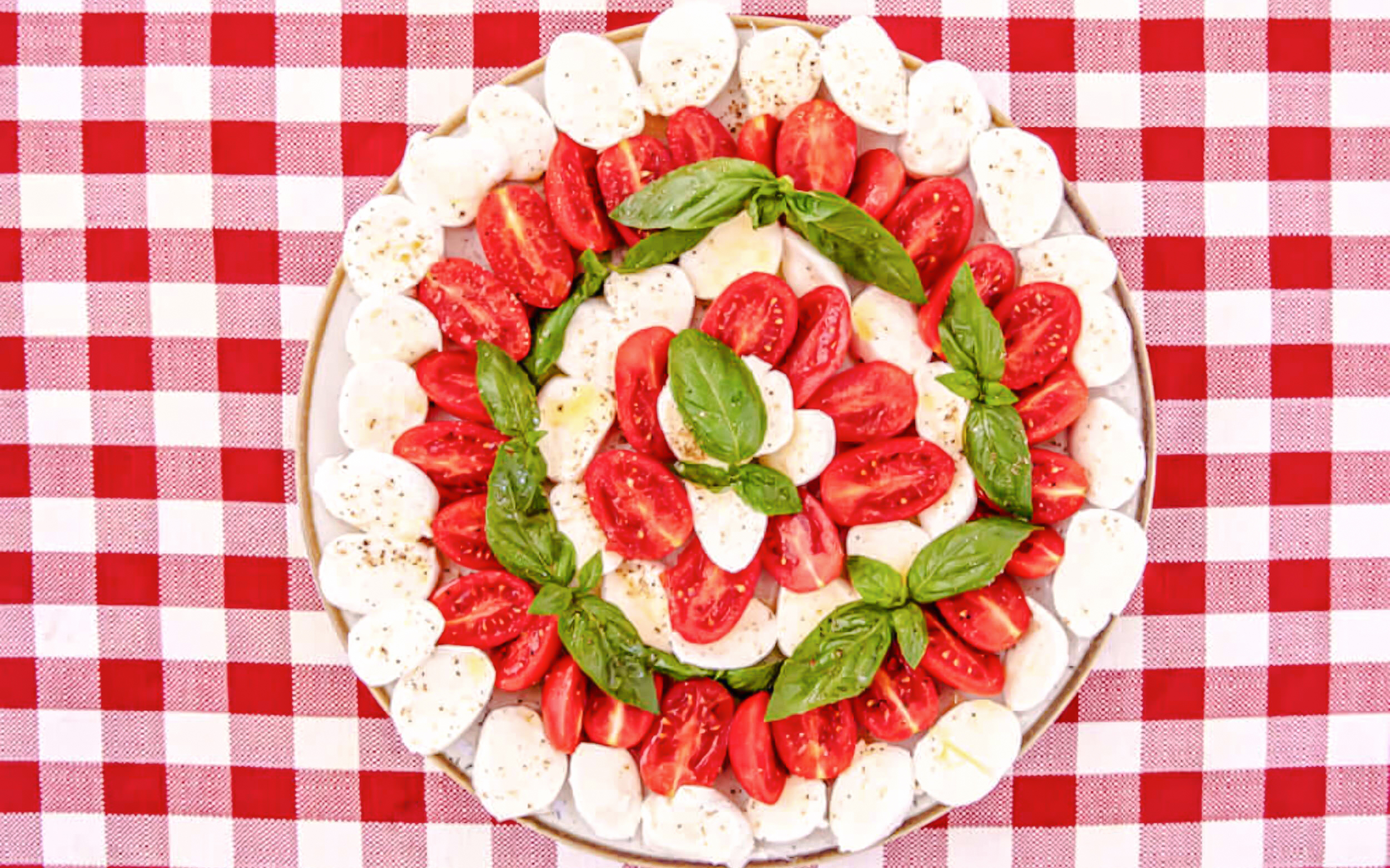 Caprese salad with tomatoes, mozzarella, and basil on a plate, Rome food tour.