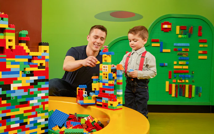 Father and child building Lego towers at LEGOLAND Discovery Centre Oberhausen.