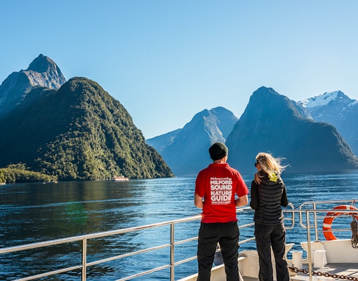 Passenger with a nature guide on a Milford Sound cruise