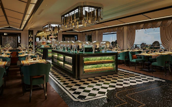 Luxury dining area on La Casta Star Cruise, Lan Ha Bay, with elegant decor and buffet setup.