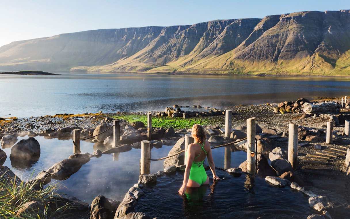 Hvammsvík Hot Spring with view of mountains and lake near Reykjavík.