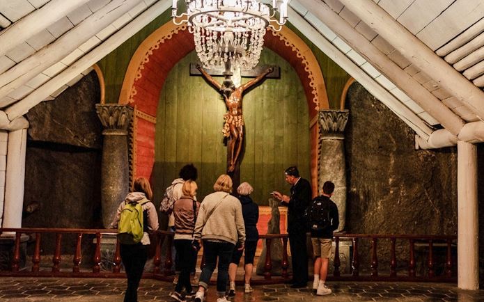 Tour group observing chapel interior at Wieliczka Salt Mine.