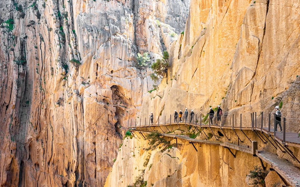 Visitors walking along the Caminito del Rey pathway in Málaga, Spain.