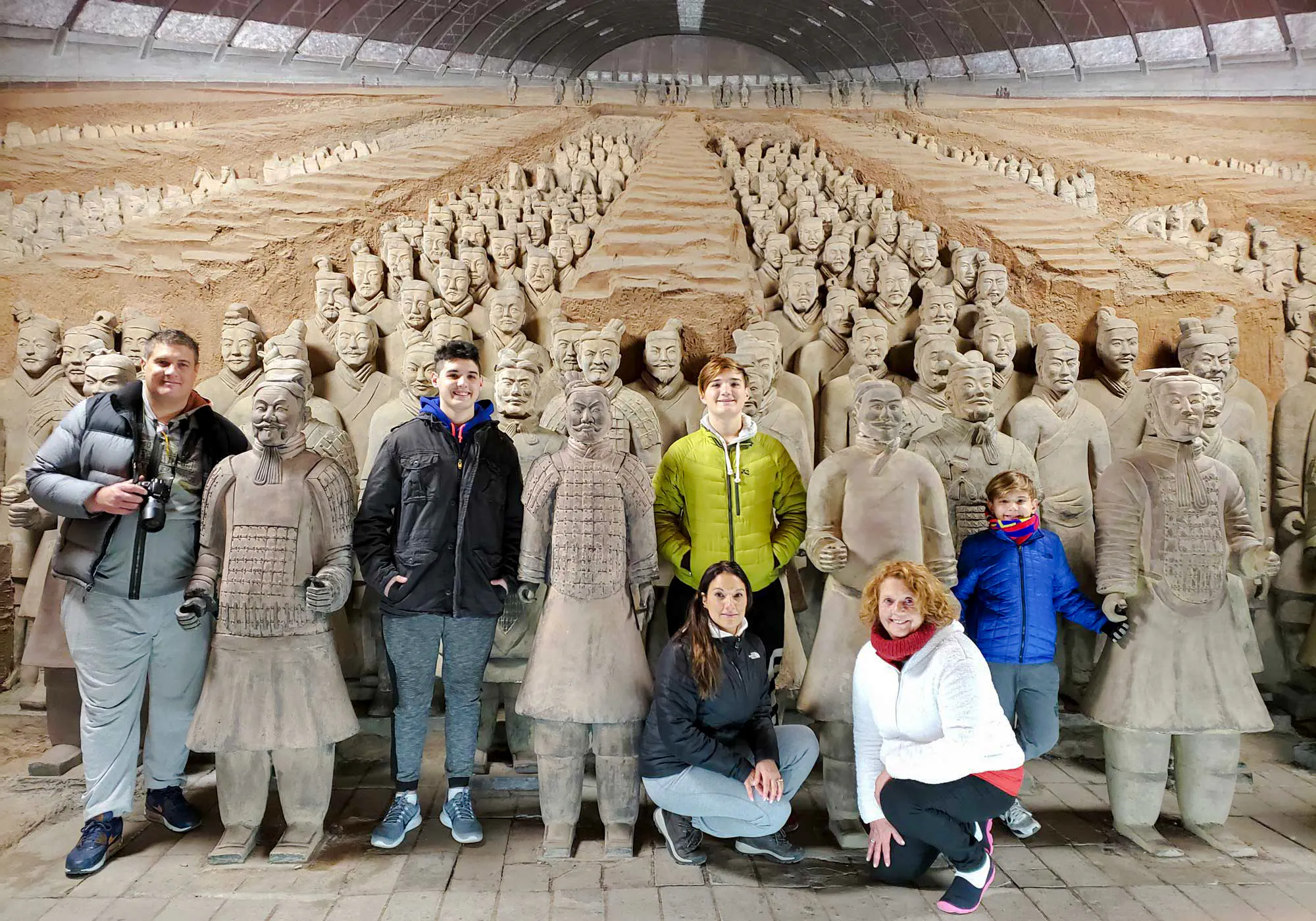 Visitors posing with Terracotta Warriors at the museum on a half-day group tour from Chengdu.