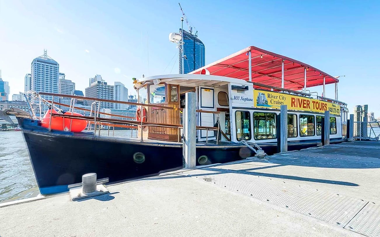 MV Neptune tour boat docked in Brisbane for River City Cruises on a sunny day.