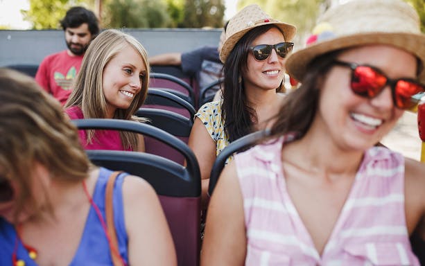 Tourists enjoying the Derry Hop-On-Hop-Off bus tour.