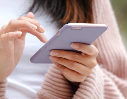 Close-up of hands using a mobile phone.