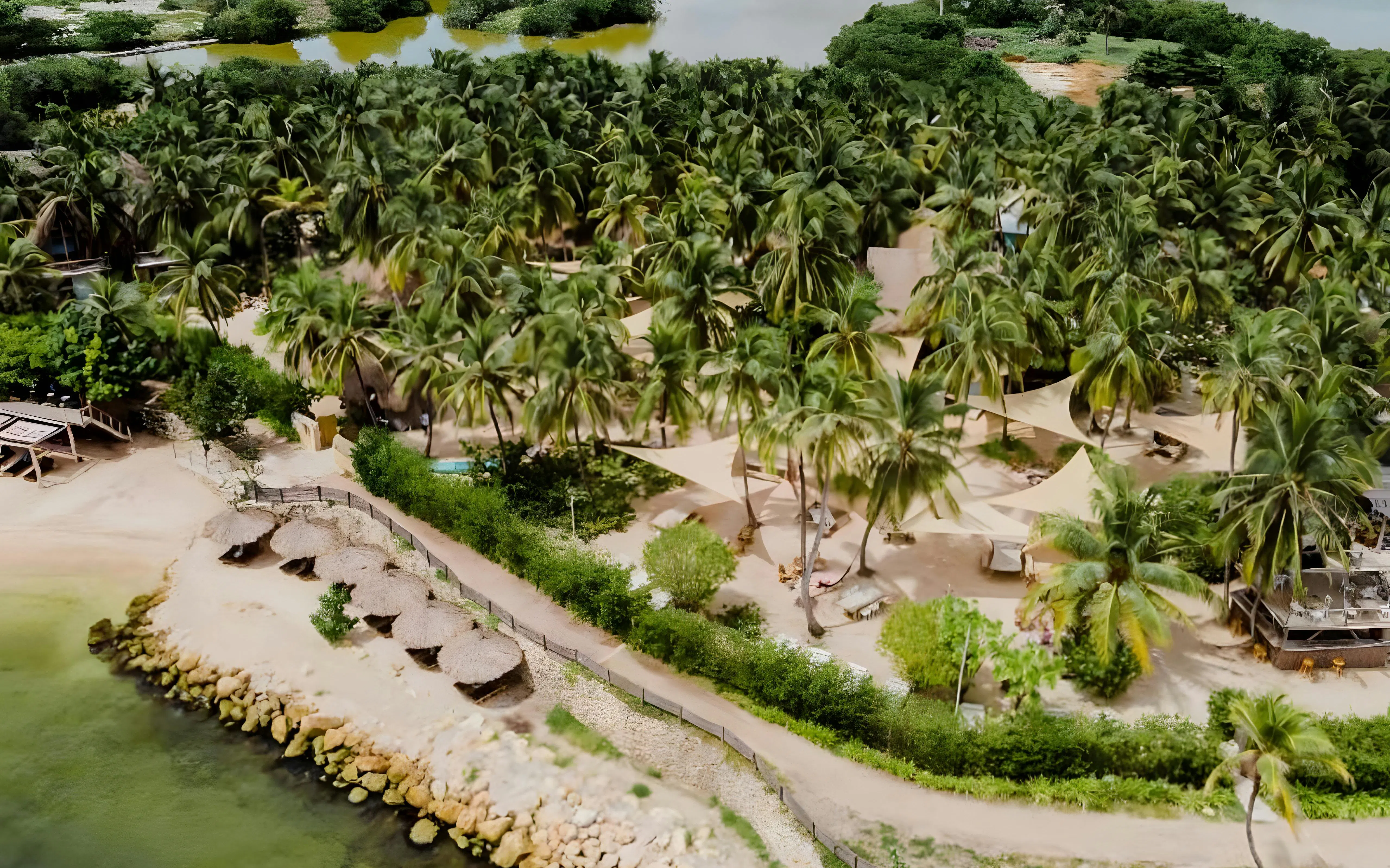 Island beach with palm trees and thatched umbrellas in the Rosario Islands near Cartagena, Colombia.