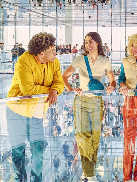 Four people standing on mirrored floor at SUMMIT One Vanderbilt, New York City.