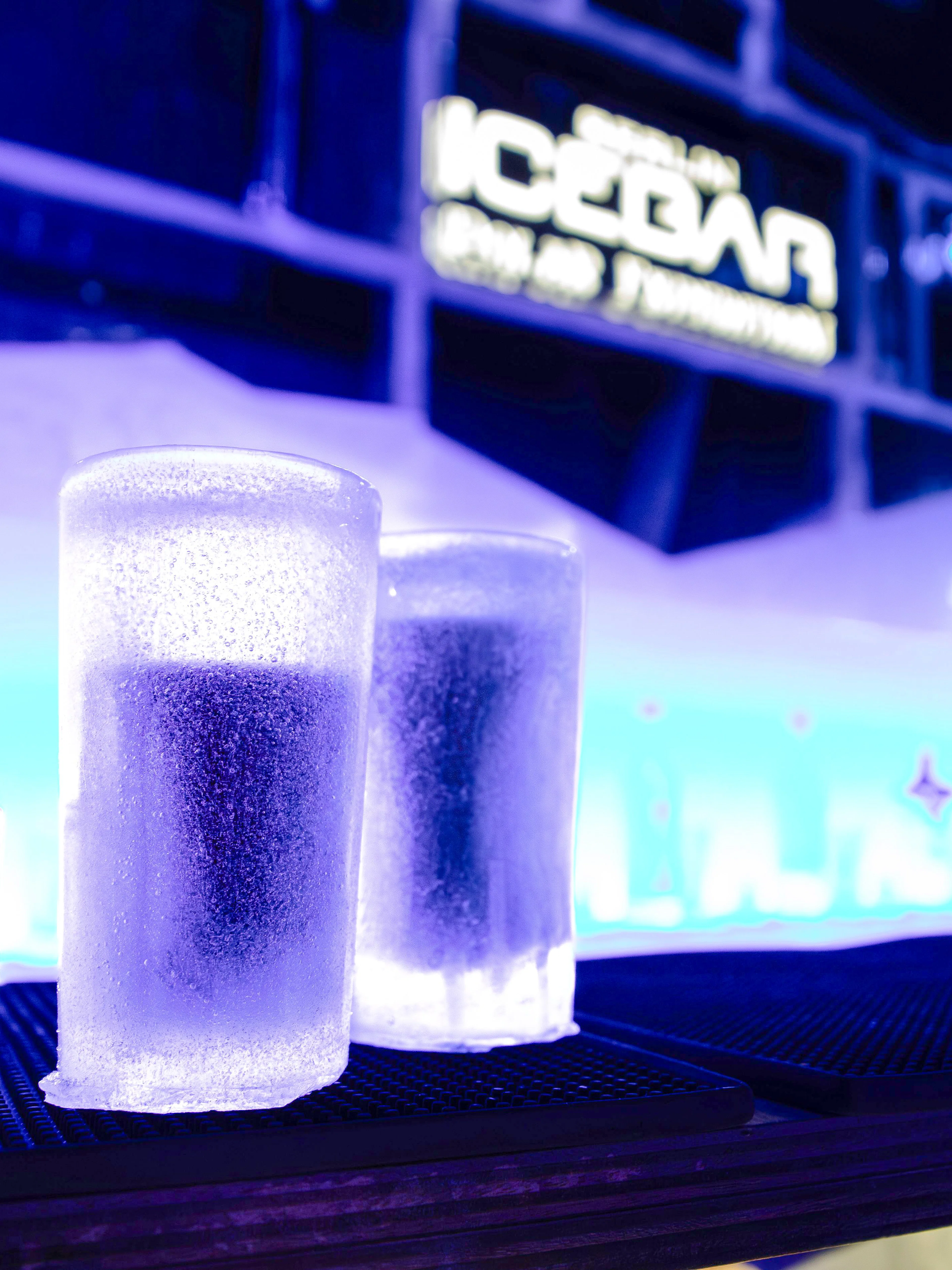Frosted ice glasses on bar counter inside Icebar Berlin.