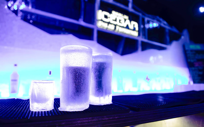 Frosted ice glasses on bar counter inside Icebar Berlin.