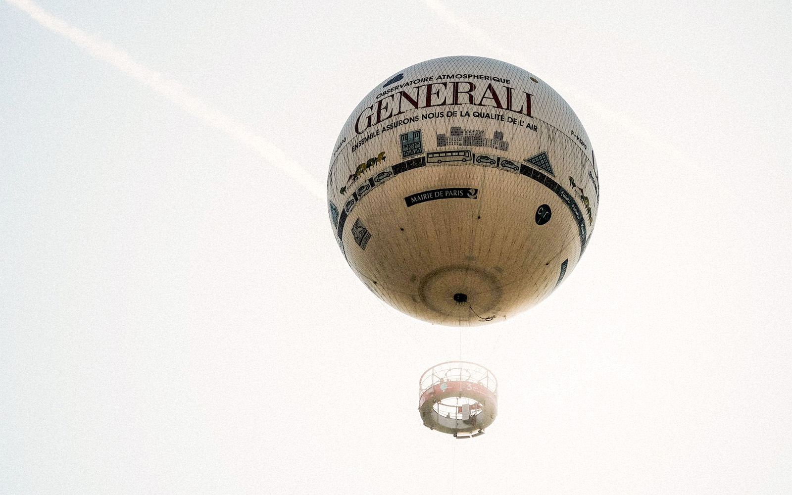 Hot air balloon floating in Paris sky with "Generali" branding.