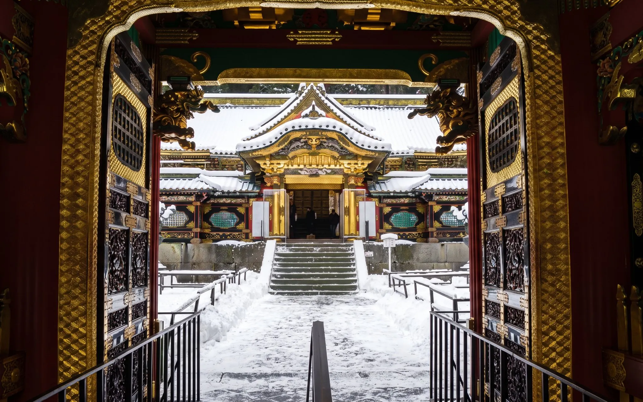 Karamon gate framed by Sakashitamon doors at snow-covered Nikkō Tōshō-gū, Japan.