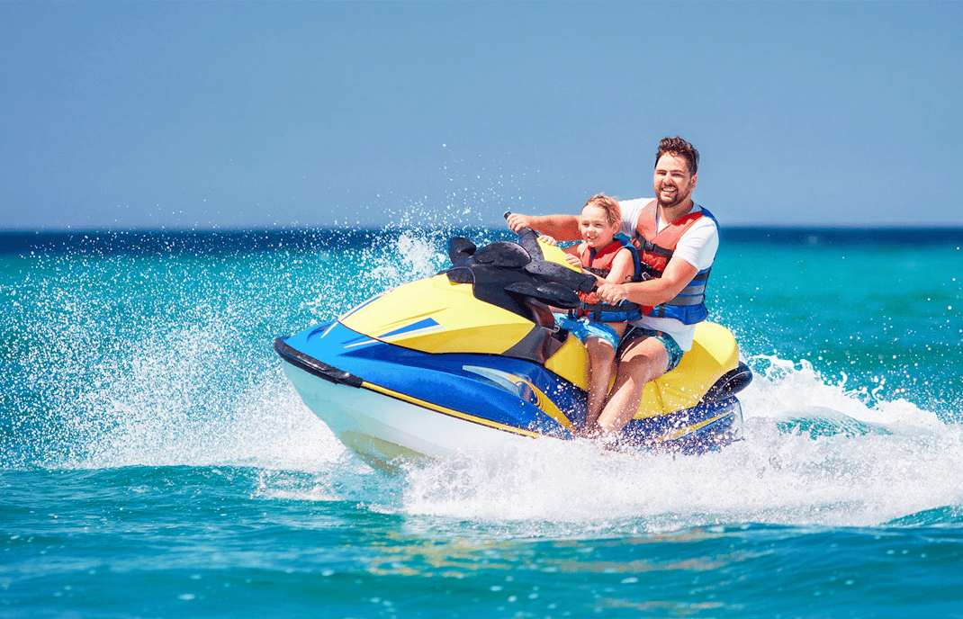 Father and son having fun on jet ski