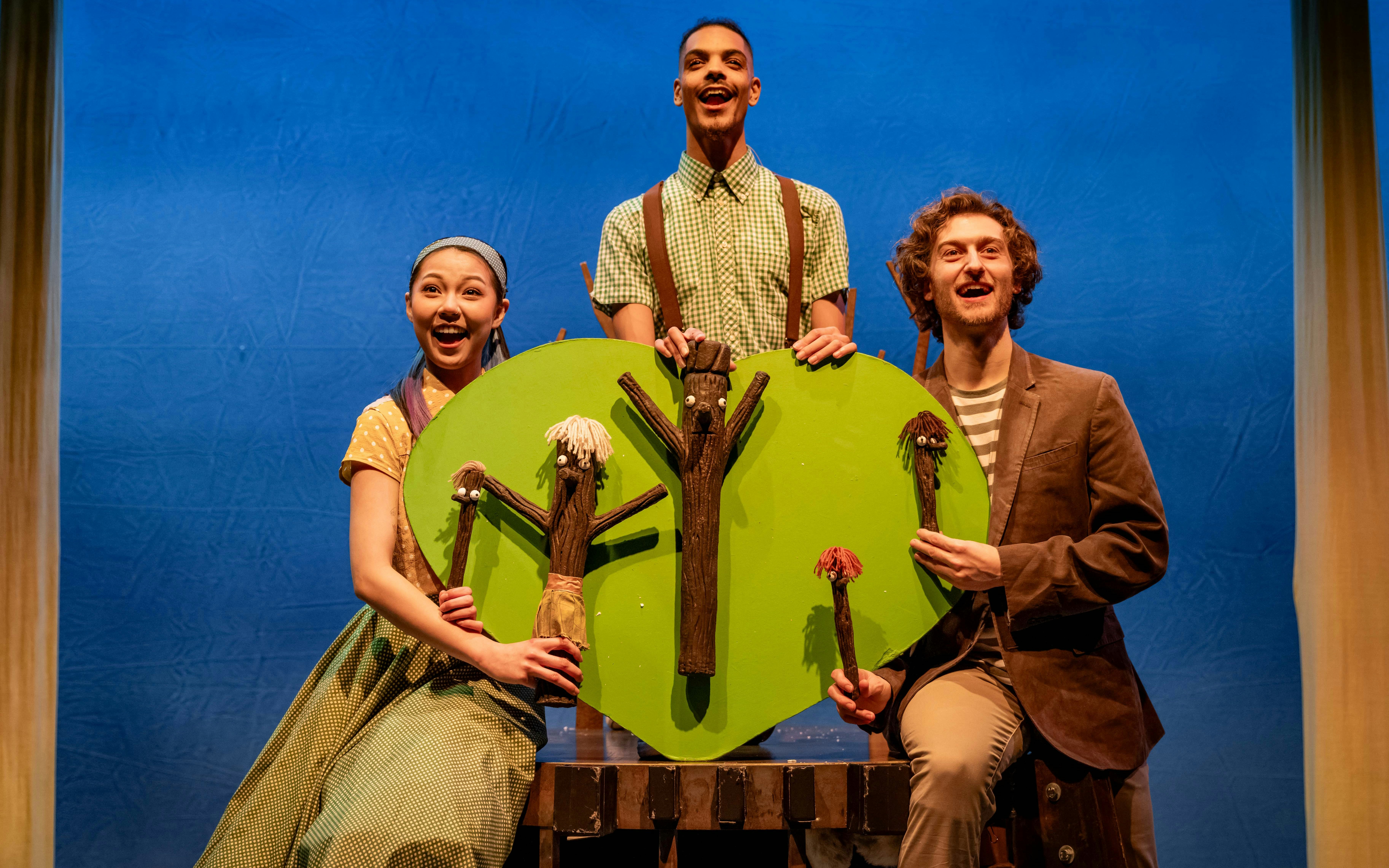 Stage performance of Stick Man with actors holding tree props, Westend.