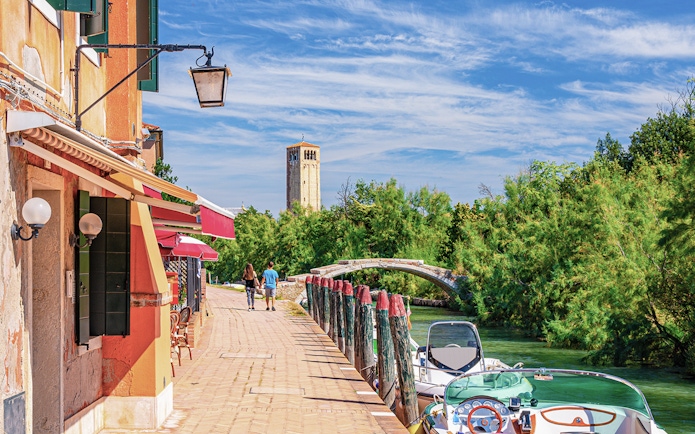 Torcello Island's Devil Bridge with nearby canal and walking path.