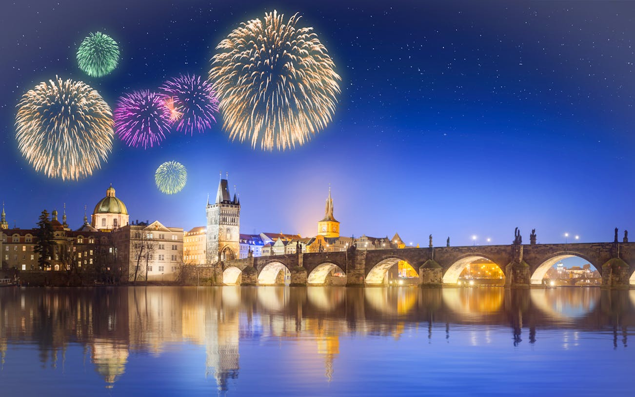 Fireworks over Charles Bridge in Prague at night.