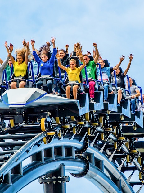 Visitors on a roller coaster at Energylandia, Poland, enjoying a thrilling ride.