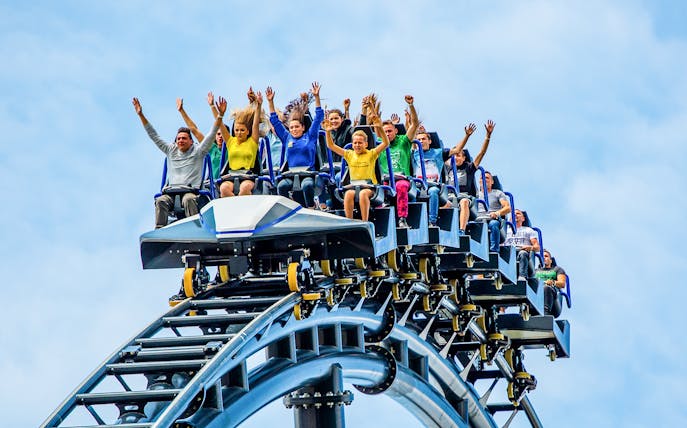 Visitors on a roller coaster at Energylandia, Poland, enjoying a thrilling ride.