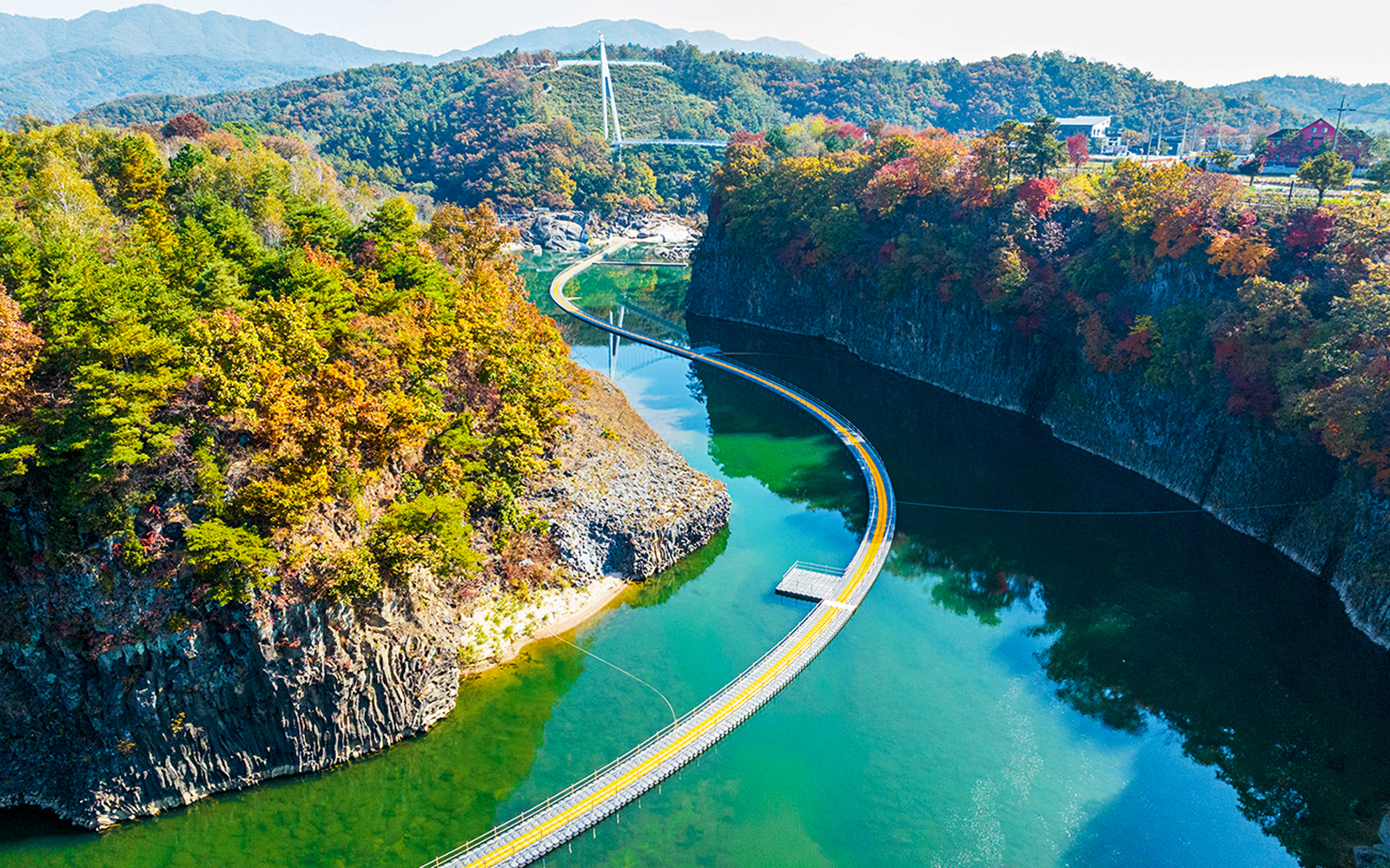 Cliffside path over a river surrounded by autumn foliage on the DMZ 2nd Tunnel tour.