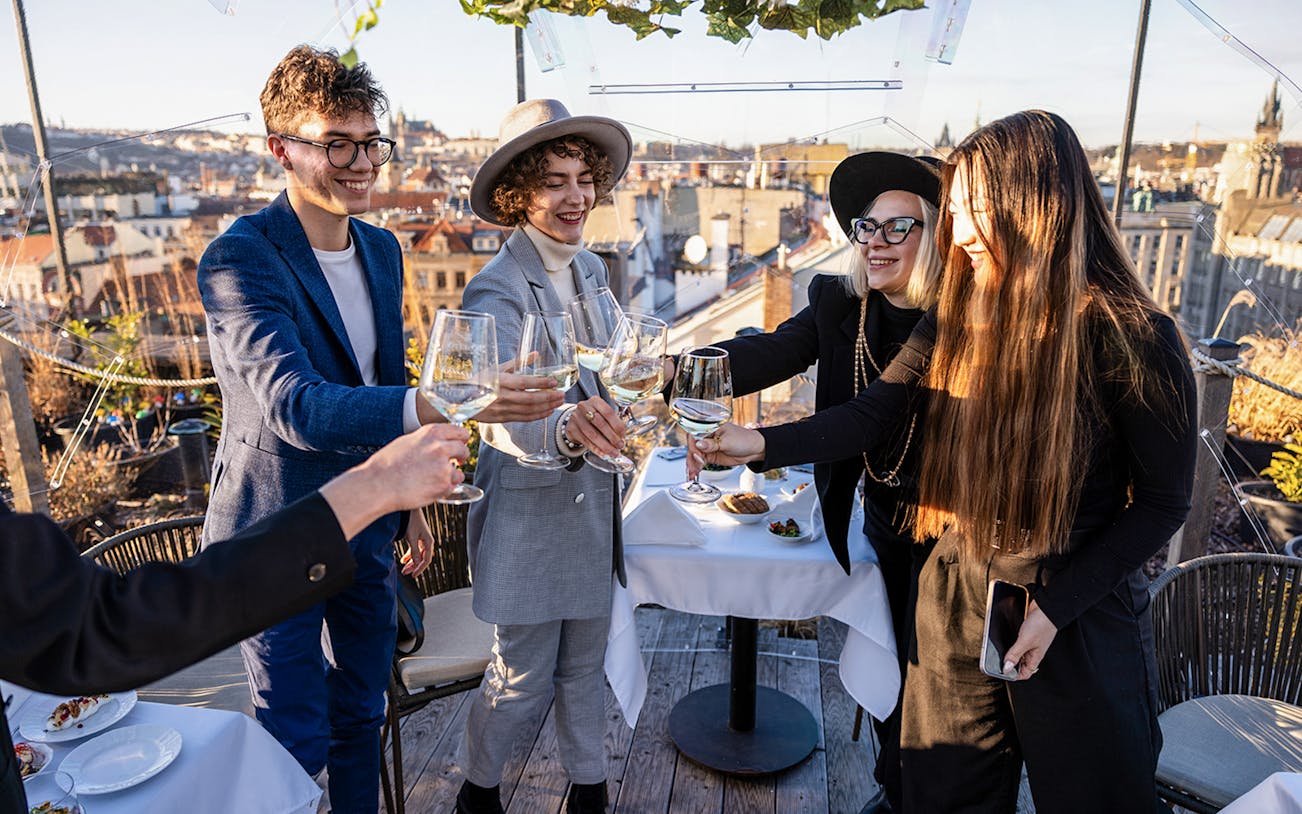 Guests toasting with drinks at Sky Bar during Prague Aperitivo tour.