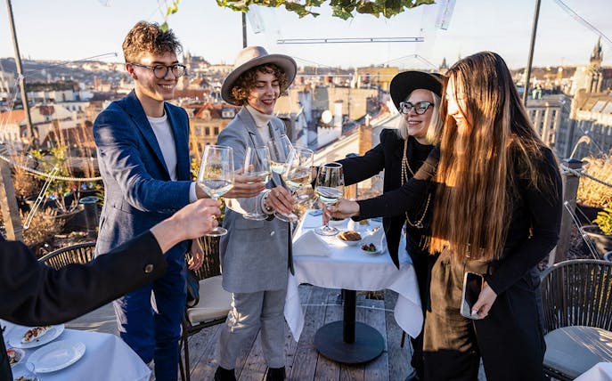 Guests toasting with drinks at Sky Bar during Prague Aperitivo tour.