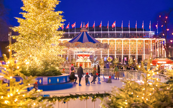 Tivoli Gardens Copenhagen Christmas decorations with lit trees and carousel.