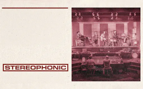 Band performing on stage with sound engineers at a mixing console, labeled "Stereophonic.