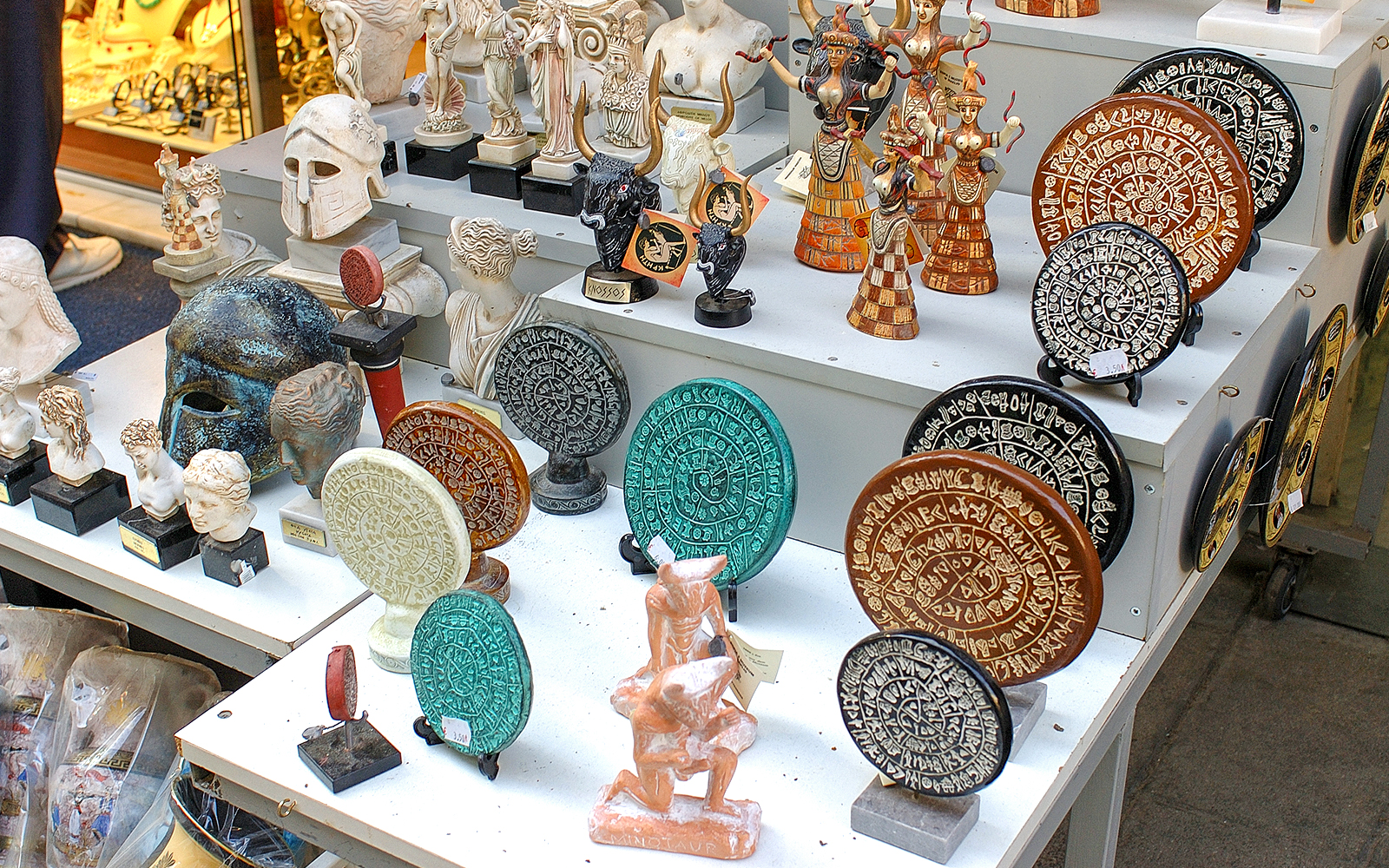 Souvenirs depicting ancient Greek artifacts at Knossos Palace site.