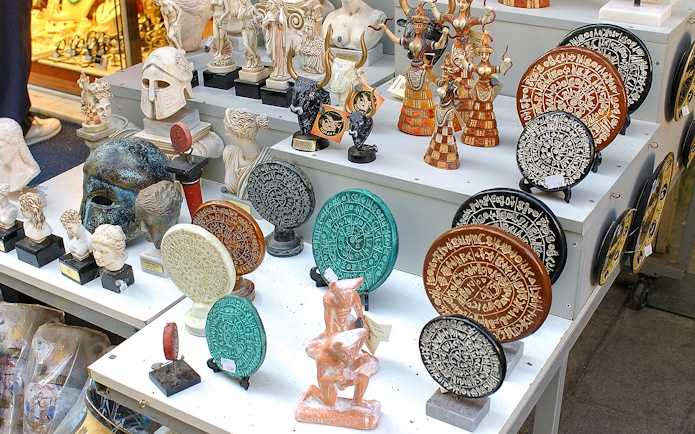 Souvenirs depicting ancient Greek artifacts at Knossos Palace site.