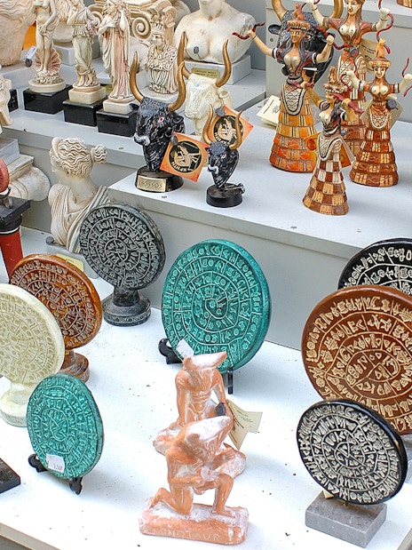 Souvenirs depicting ancient Greek artifacts at Knossos Palace site.