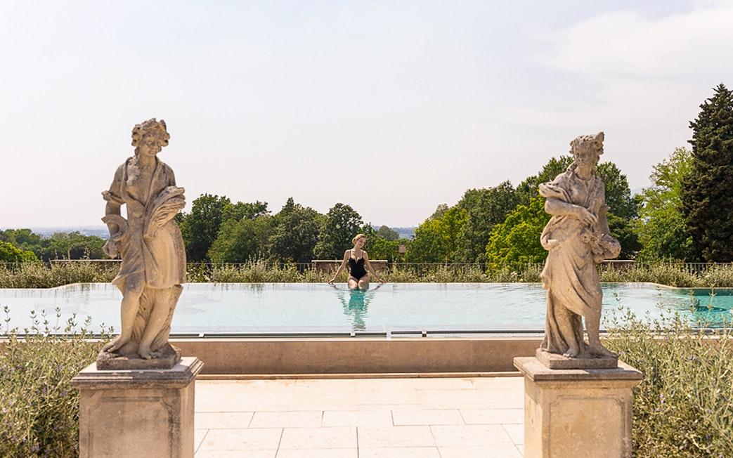 Infinity pool with statues at QC Terme Garda, Italy.