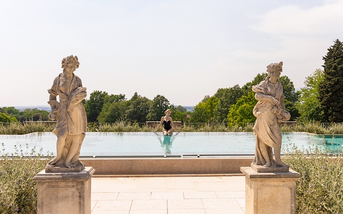 Infinity pool with statues at QC Terme Garda, Italy.