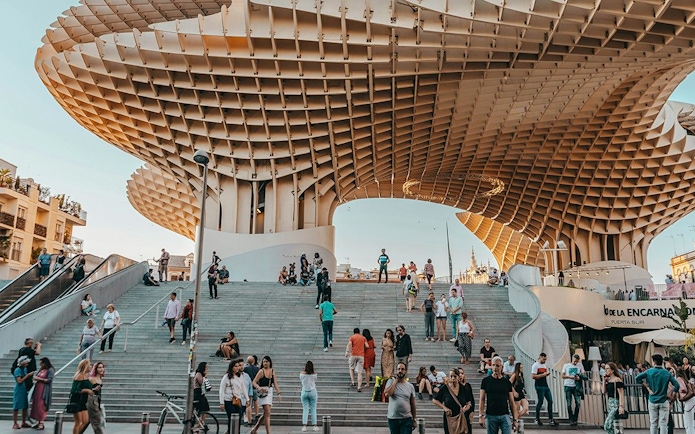 Tourists exploring Setas de Sevilla during a city guided tour.
