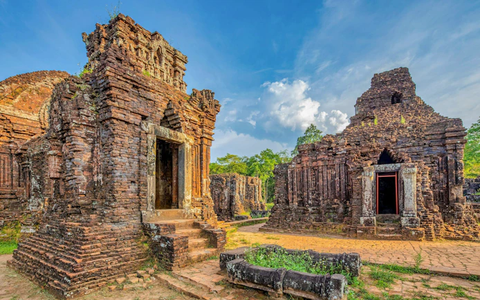 My Son Sanctuary ancient Cham temples in Quang Nam, Vietnam, surrounded by lush greenery.