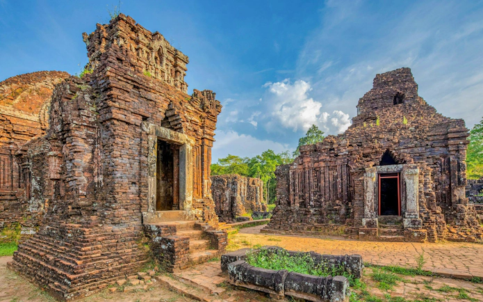 My Son Sanctuary ancient Cham temples in Quang Nam, Vietnam, surrounded by lush greenery.