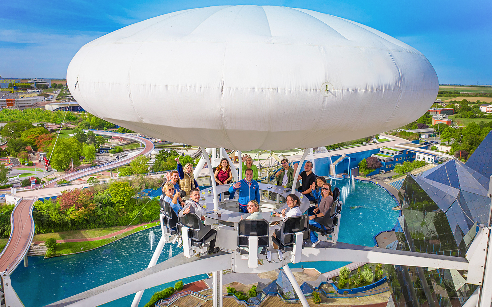 Visitors enjoying the Aerobar at Futuroscope, France, with panoramic park views.