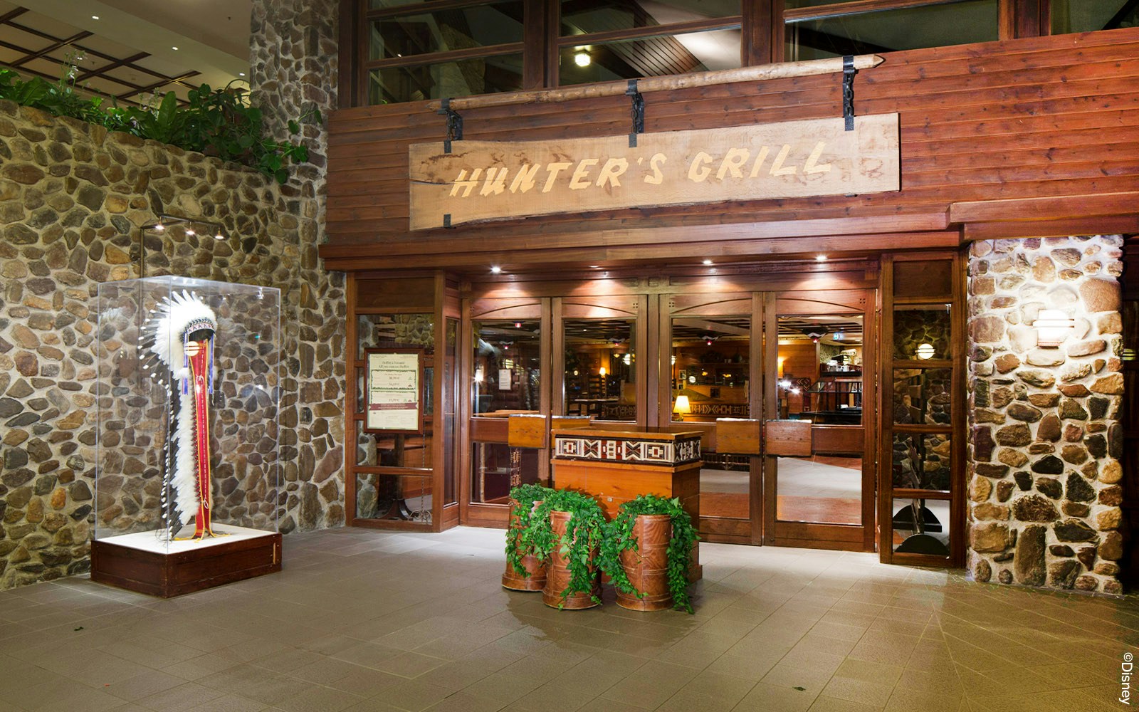 Hunter's Grill restaurant entrance at Disneyland Paris with outdoor seating area.