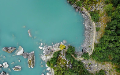 Aerial view of Bondhusvatnet Lake with rocky shoreline and forest, Folgefonna National Park, Norway.