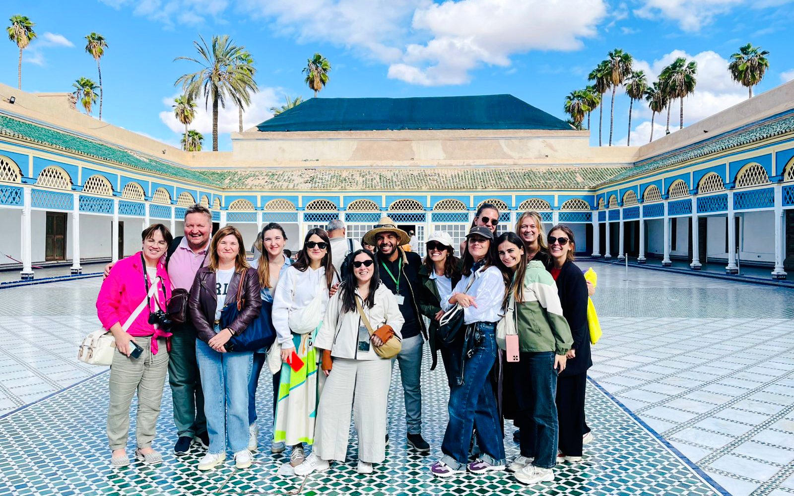 Tourists with a guide in the courtyard of Bahia Palace, Marrakech, Morocco.