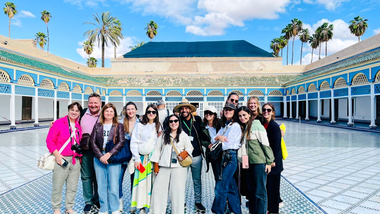 Tourists with a guide in the courtyard of Bahia Palace, Marrakech, Morocco.