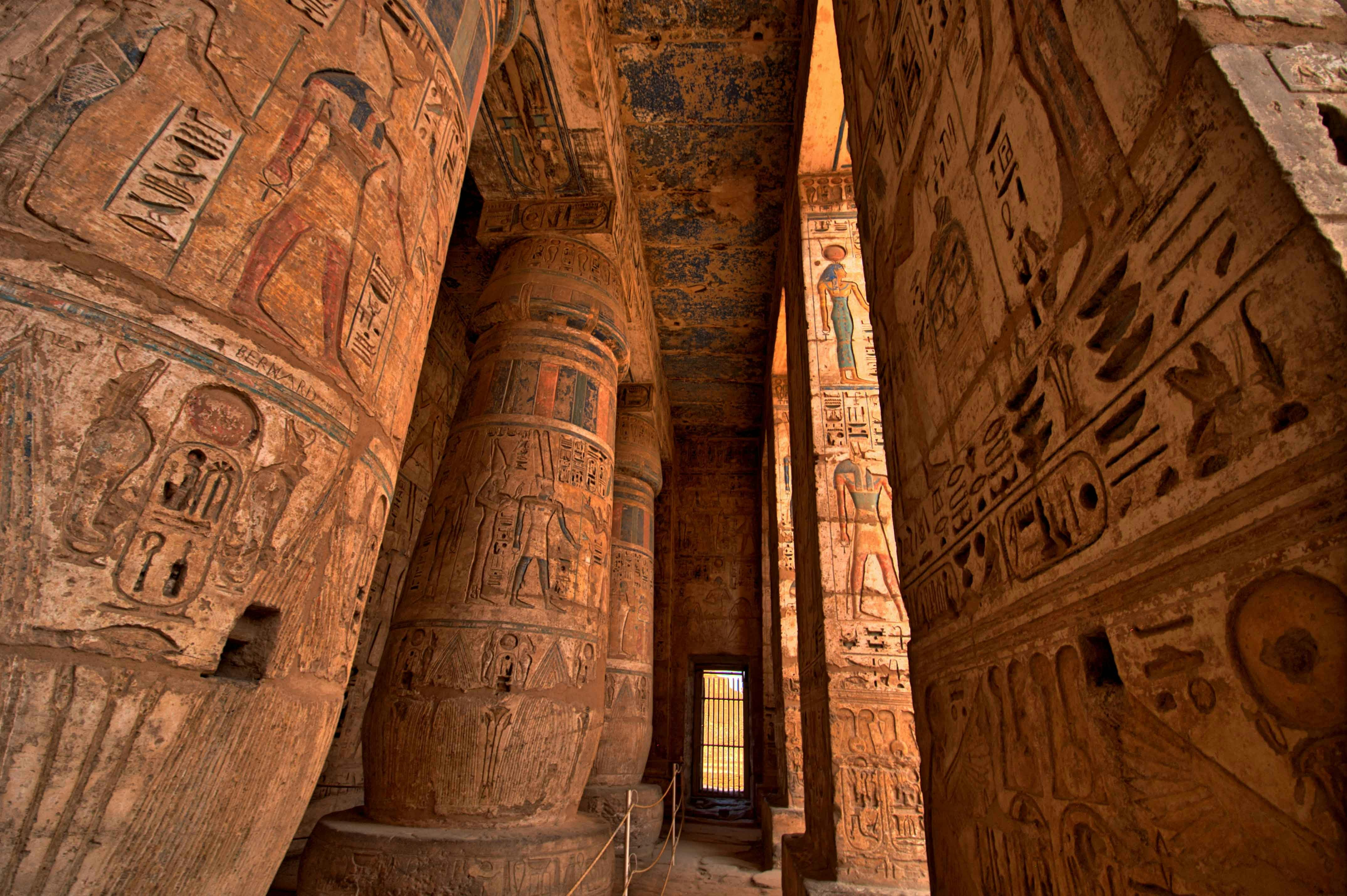 Temple of Hatshepsut interior with hieroglyphs and carved columns in Luxor, Egypt.
