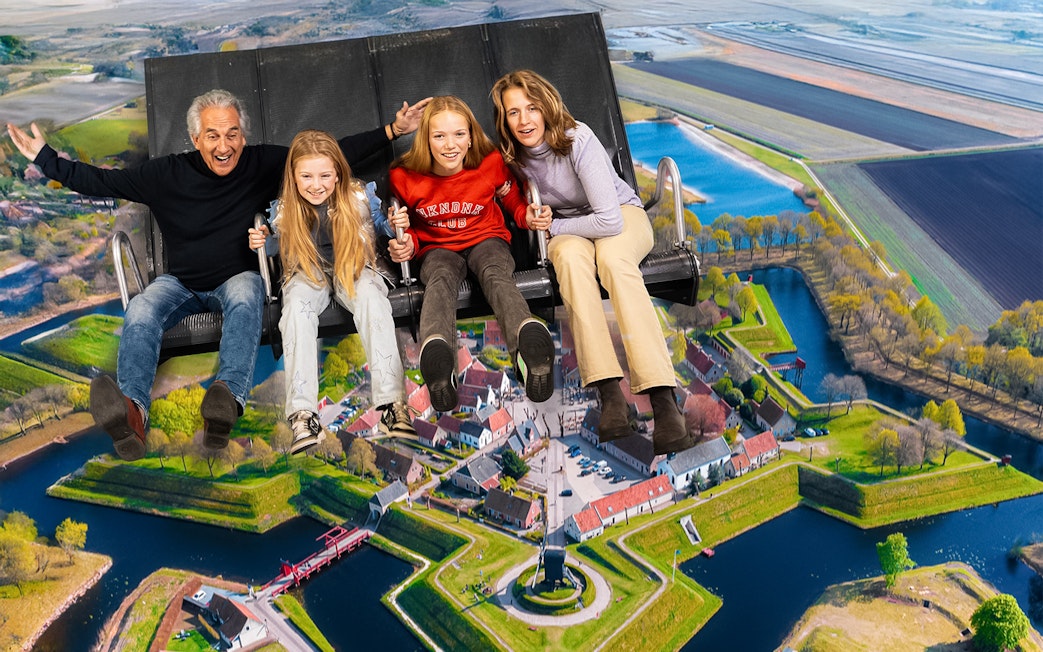 Tourists on 5D ride at This Is Holland, flying over Dutch landscape.