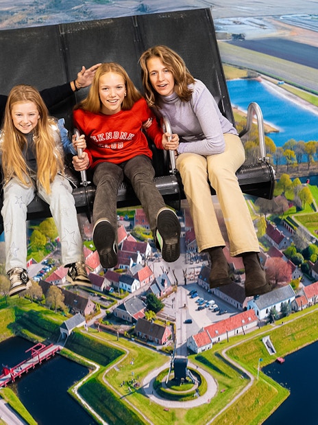 Tourists on 5D ride at This Is Holland, flying over Dutch landscape.