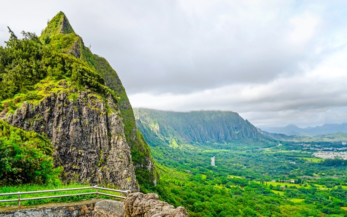 Nuuanu Pali Lookout view of lush green cliffs and valley in Honolulu, Hawaii.