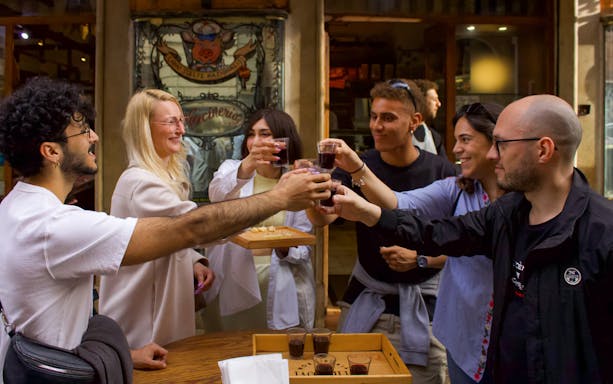 Group enjoying wine tasting during a food tour in Trastevere, Rome.