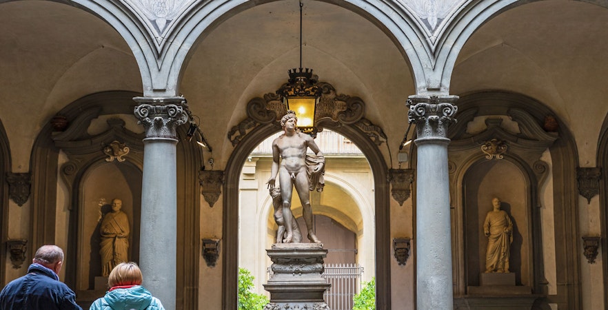 Tourists viewing Michelangelo's David in Galleria Accademia, Florence, Italy.