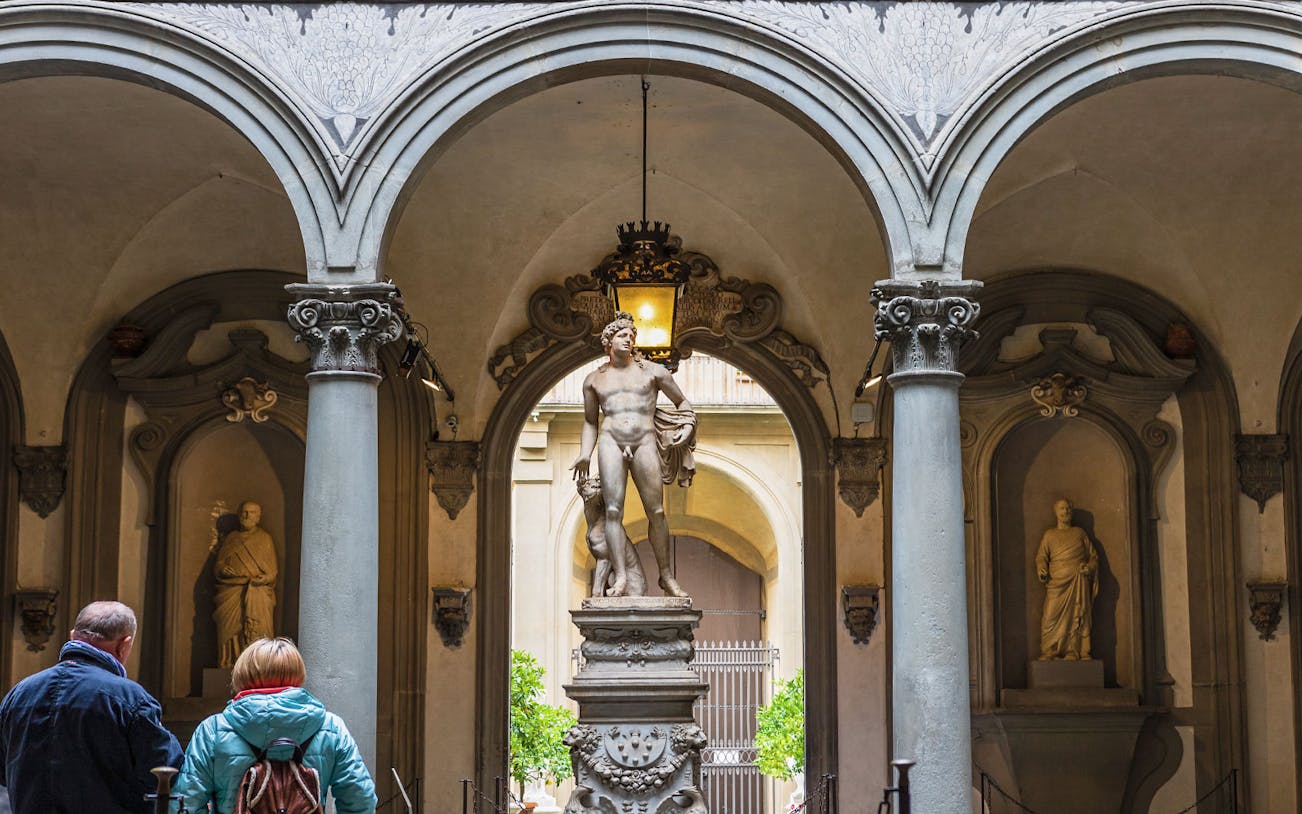 Tourists viewing Michelangelo's David in Galleria Accademia, Florence, Italy.